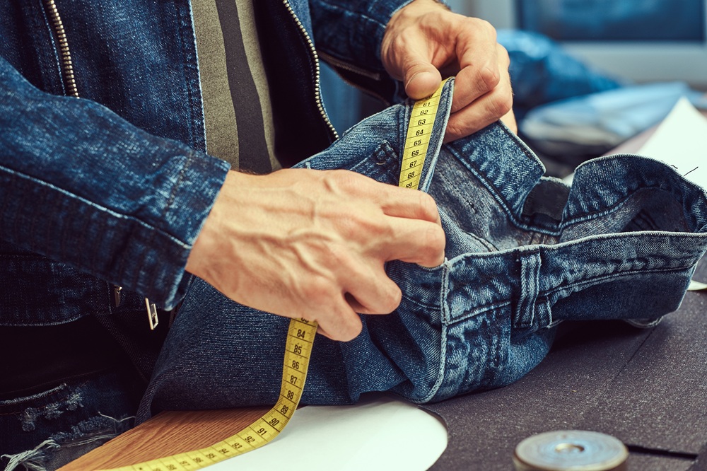 A man working on a sewing machine.