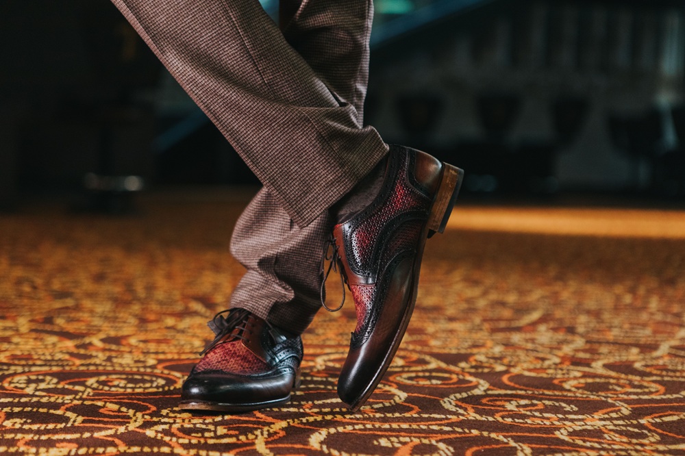 A man working on a sewing machine.